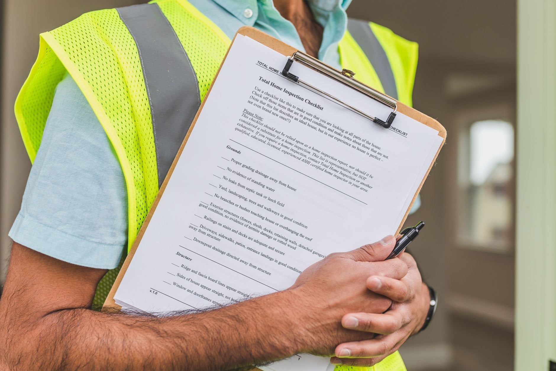 Inspector reviewing property checklist on clipboard